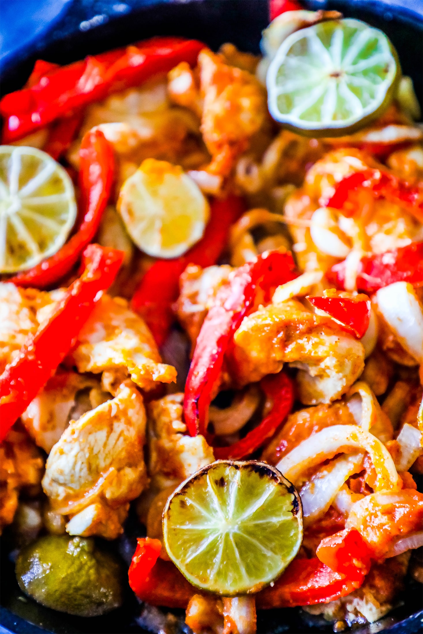 chicken, bell peppers, and lime in a pan