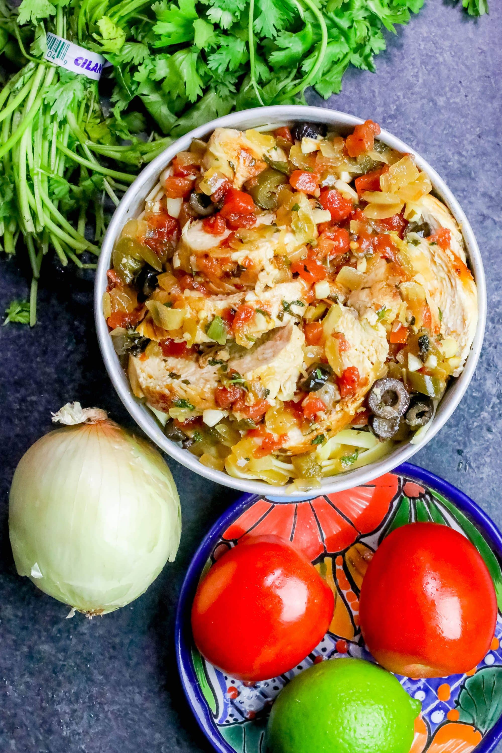 chicken on pasta with vegetables on it