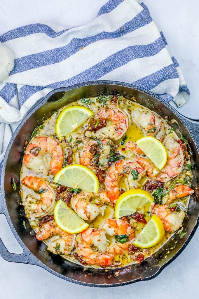 shrimp in a skillet with lemon and butter