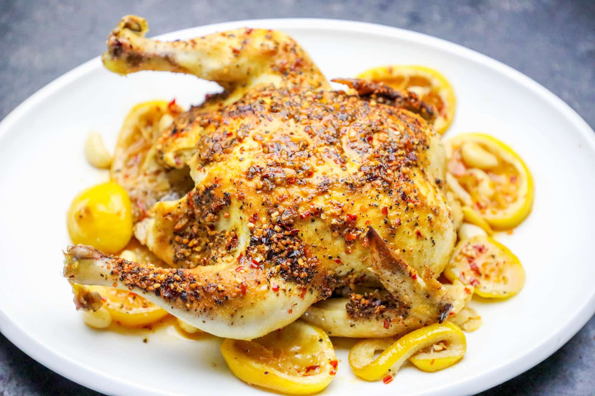 whole chicken covered in herbs roasted with lemons and garlic as the base