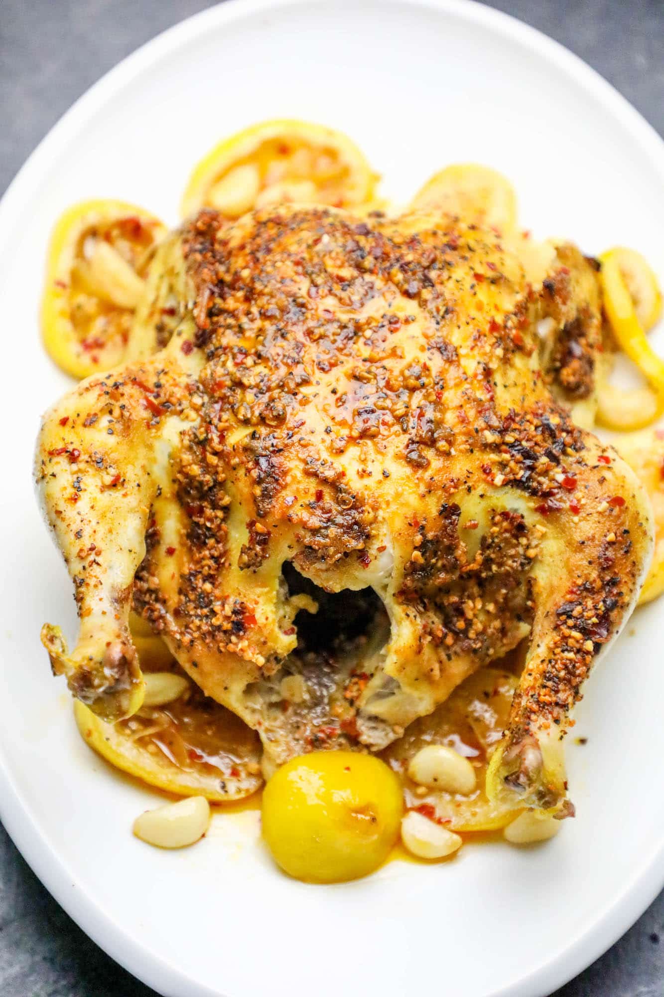 whole chicken covered in herbs roasted with lemons and garlic as the base