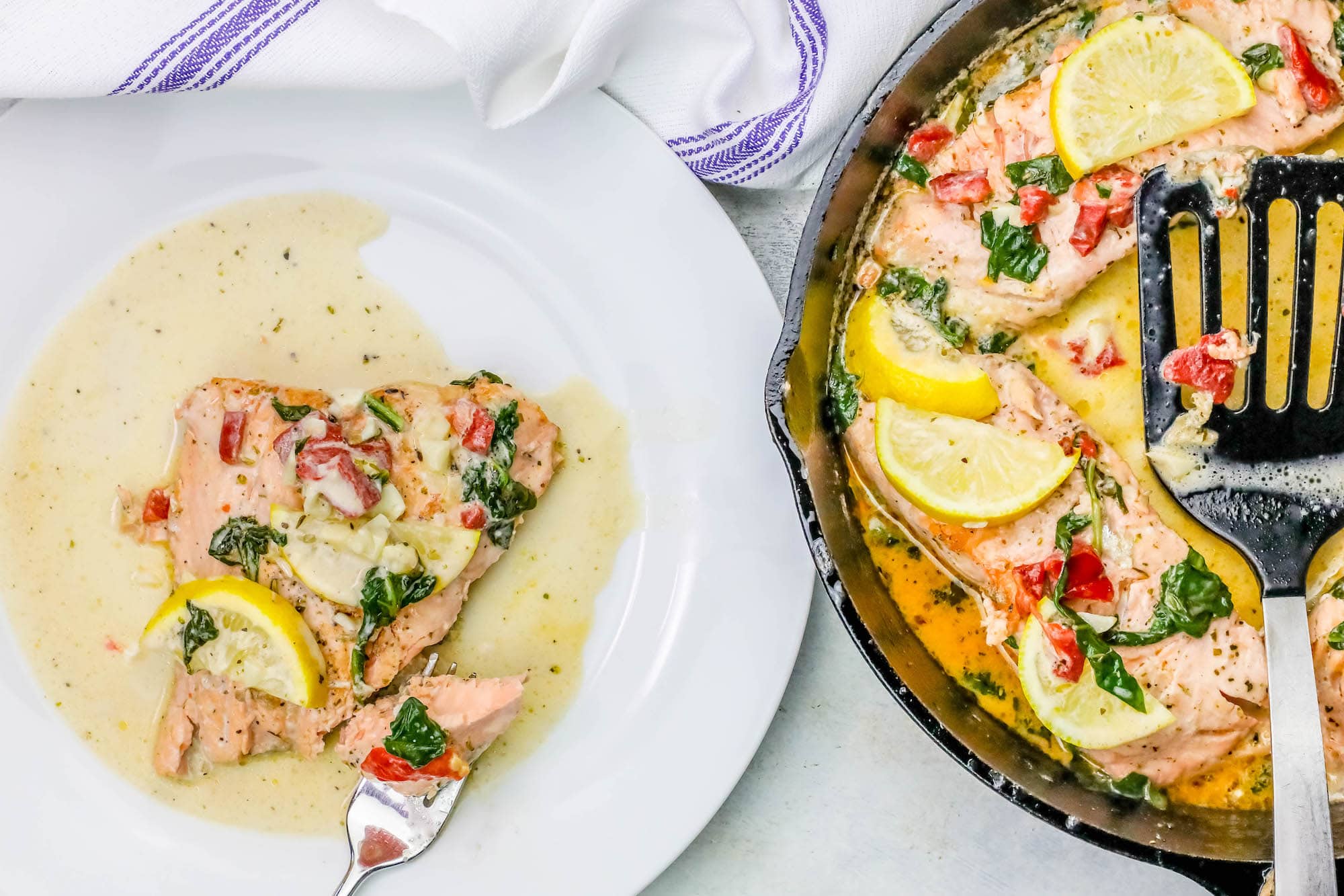 salmon, peppers, lemons, and spinach in a creamy sauce