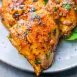 Close-up of easy blackened chicken thighs cooked to perfection, showcasing their seasoned, crispy exterior on a plate.