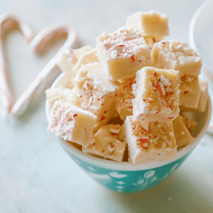 Candy cane fudge recipe in a bowl with candy canes.