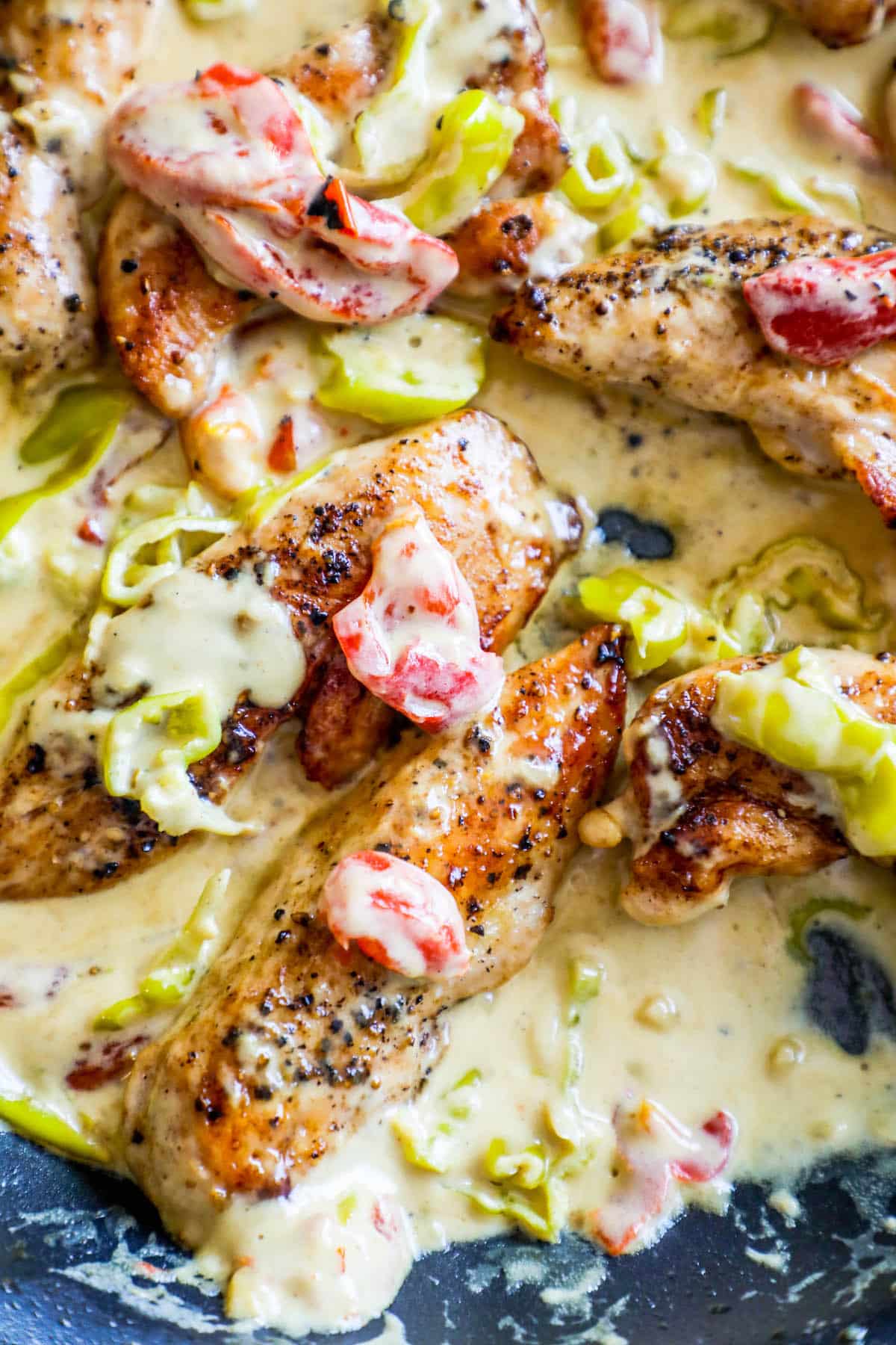 chicken in a creamy sauce with tomatoes and pepperoncini