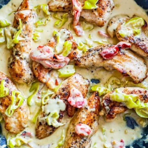 chicken in a white sauce with peppers and pepperoncini