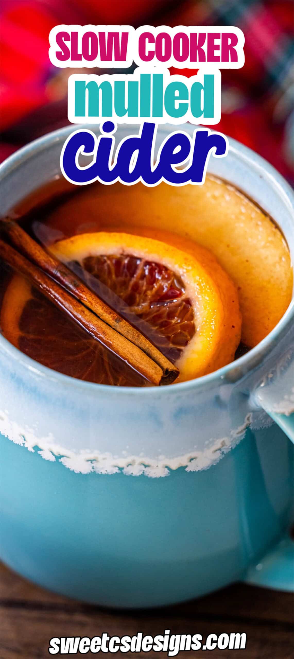 A blue mug filled with the Best Mulled Cider Ever, garnished with orange slices and cinnamon sticks. Text reads "Slow Cooker Mulled Cider" and "sweetcsdesigns.com" at the bottom.