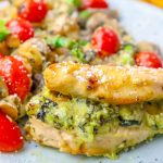 Creamy spinach and artichoke dip stuffed chicken served with vegetables.
