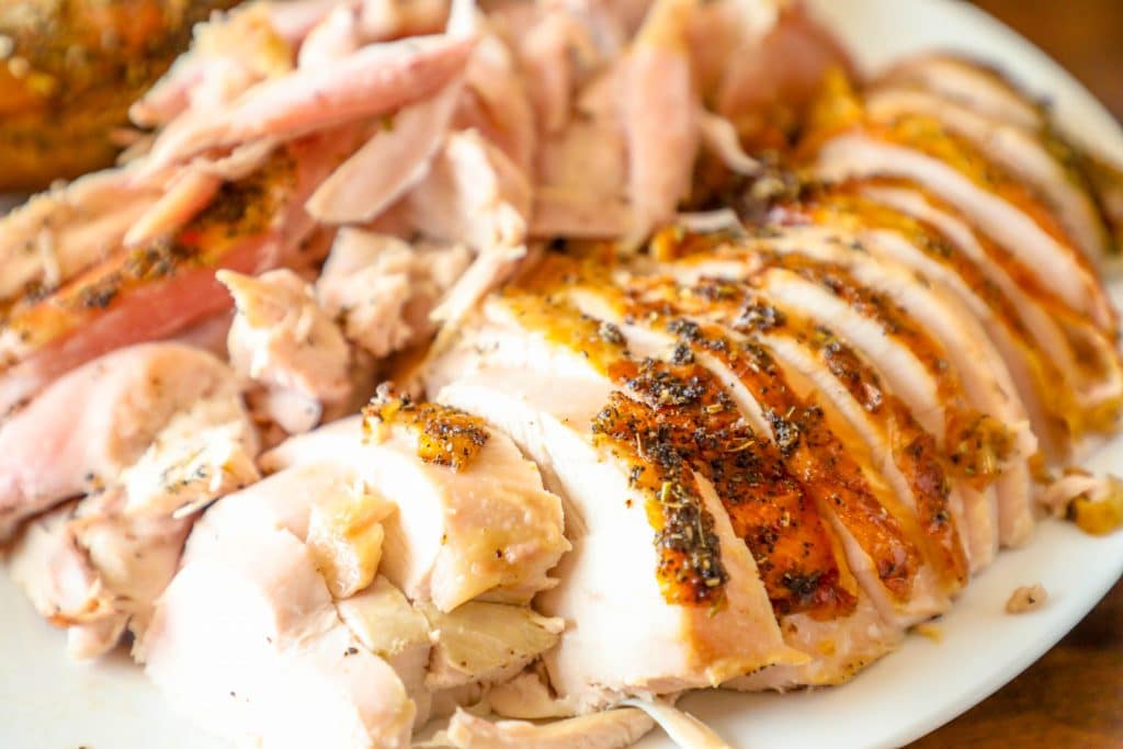 picture of crispy skin roasted turkey with herbs on a white plate
