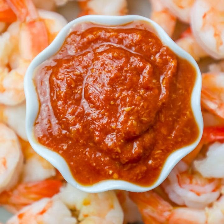 Homemade shrimp cocktail recipe served with delicious homemade cocktail sauce in a white bowl.