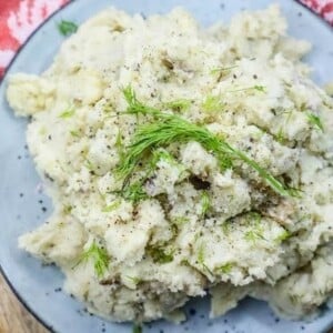 Instant Pot mashed potatoes with dill sprinkled on top.