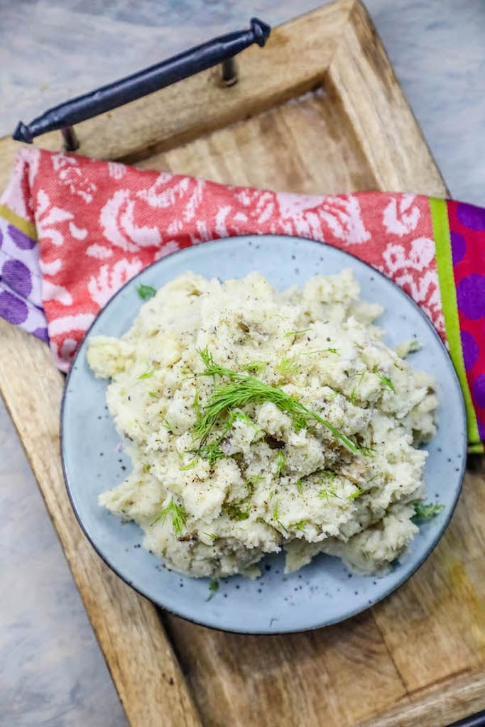 potatoes in a bowl with dill on it