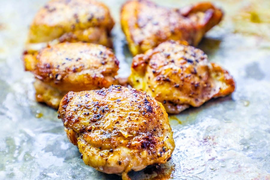 baked chicken thigh on baking sheet. 