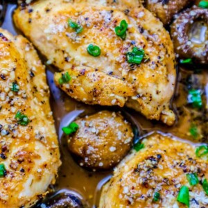 Easy garlic butter chicken breasts in a sauce with mushrooms and olives.