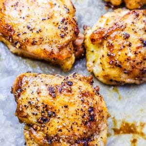 Chicken breasts baked on a sheet.