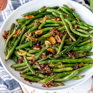 picture of chinese garlic green beans in a white bowl on a table
