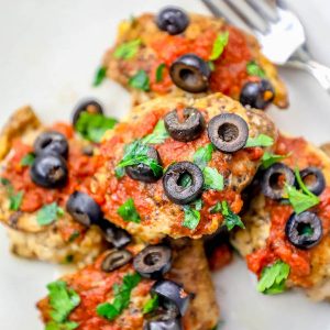 30-minute Mexican chicken thighs with olives and tomatoes, served on a plate.