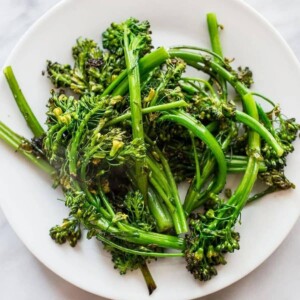 picture of pan fried broccolini on a white plate