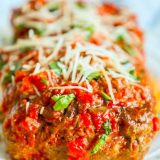 The best easy baked Italian meatloaf recipe ever, topped with sauce and parmesan cheese.