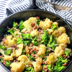A skillet filled with oven roasted broccoli and bacon.
