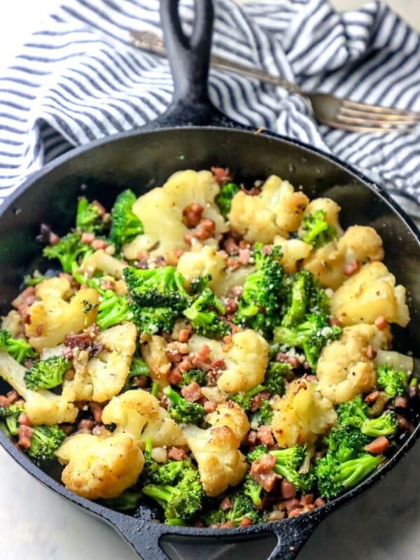 A skillet filled with oven roasted broccoli and bacon.