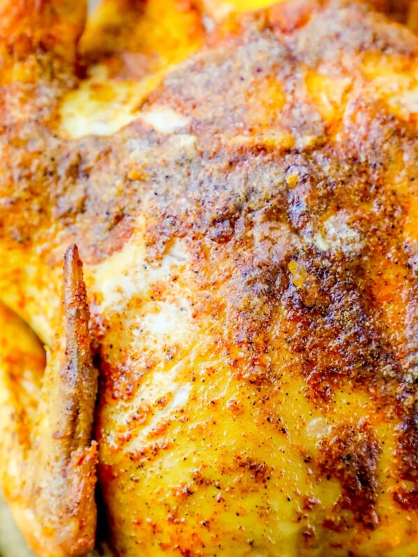 A Cajun roasted chicken on a baking sheet.