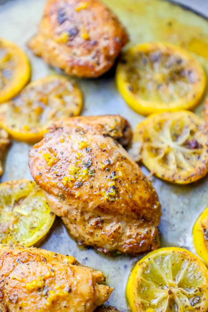 picture of chicken thighs with lemons in a pan