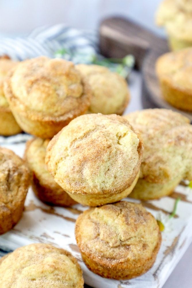 Picture of muffins covered in cinnamon sugar piled on a cutting board