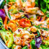 A spicy Thai shrimp salad with lettuce and vegetables.