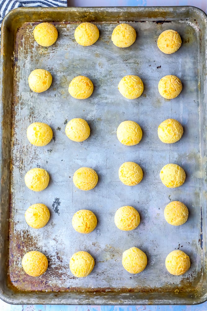a bunch of cheese balls on a sheet pan