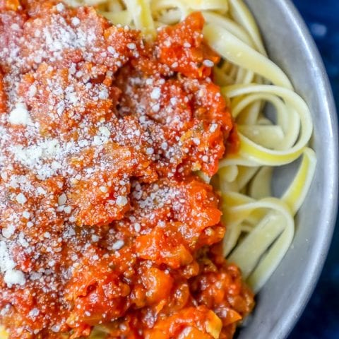 A keto vegan pasta dish with red pepper sauce and parmesan cheese.