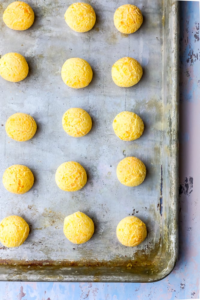 a bunch of cheese balls on a sheet pan