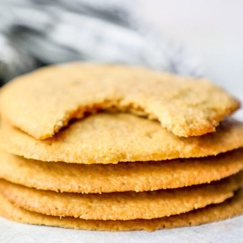 A stack of easy keto peanut butter cookies with a bite taken out of them.