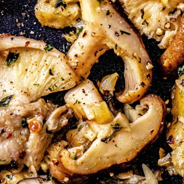 Best Garlic Butter Mushrooms sautéed in a skillet with herbs.