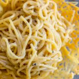 The best Cacio e Pepe recipe served in a basket with a fork.