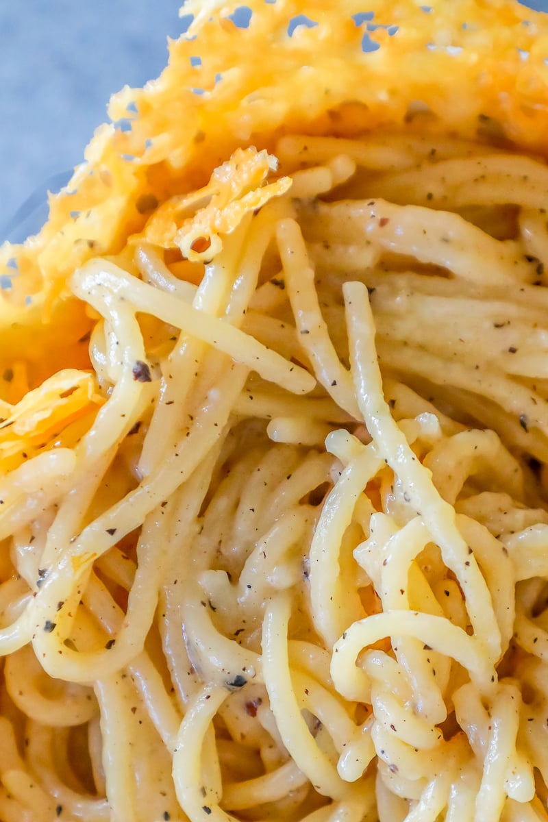 parmesan and pepper creamy pasta in a parmesan bowl on a table