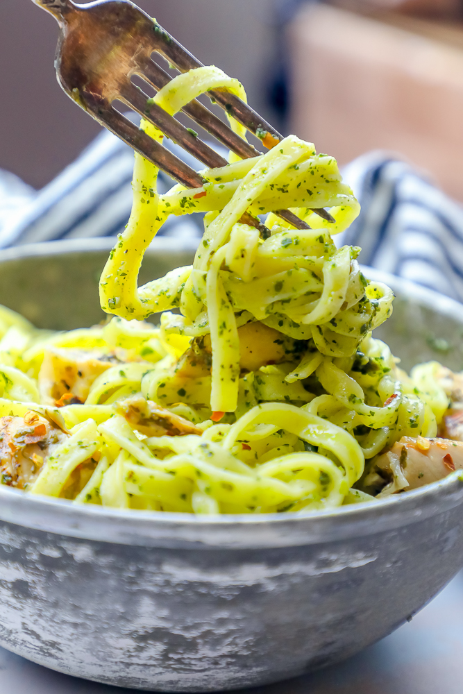 A bowl of chimichurri pasta with a fork in it.