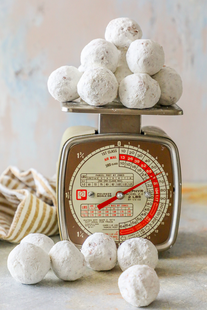 powdered sugar donut holes on a home scale