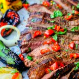 Grilled steak with peppers and onions on a baking sheet, the Best Grilled Carne Asada Recipe Ever.