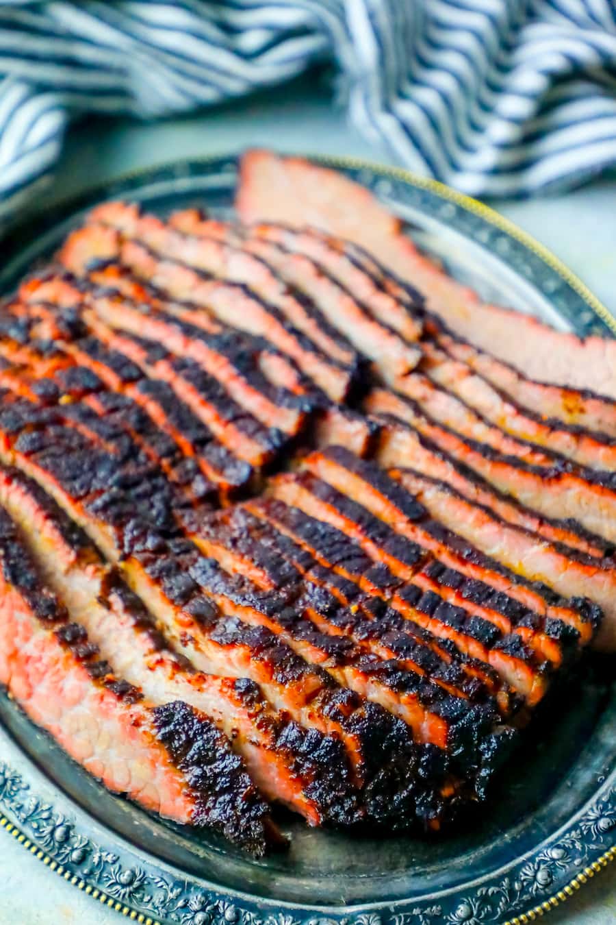 smoked brisket sliced on an antique metal plate