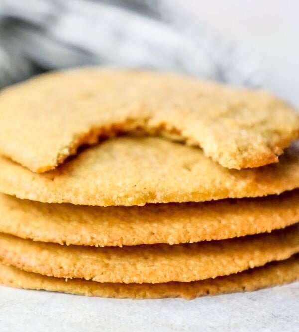 A stack of easy keto peanut butter cookies with a bite taken out of them.