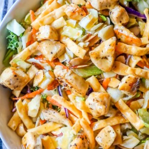 Chicken noodle salad in a white bowl, inspired by The Best Chopped Chinese Chicken Salad.