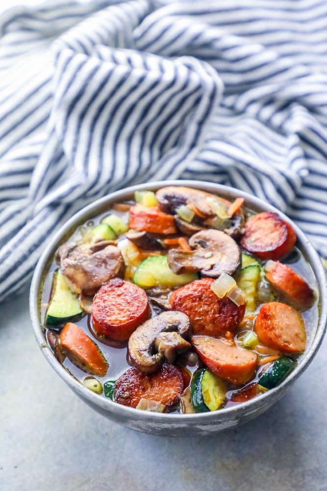 sausage, mushrooms, zucchini in a soup bowl