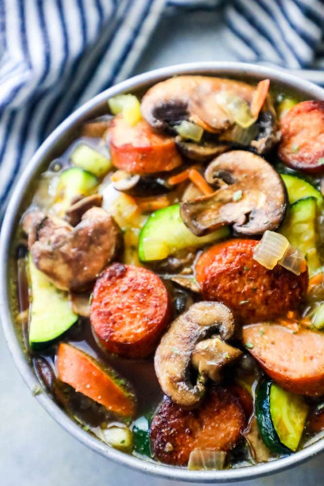 sausage, mushrooms, zucchini in a soup bowl