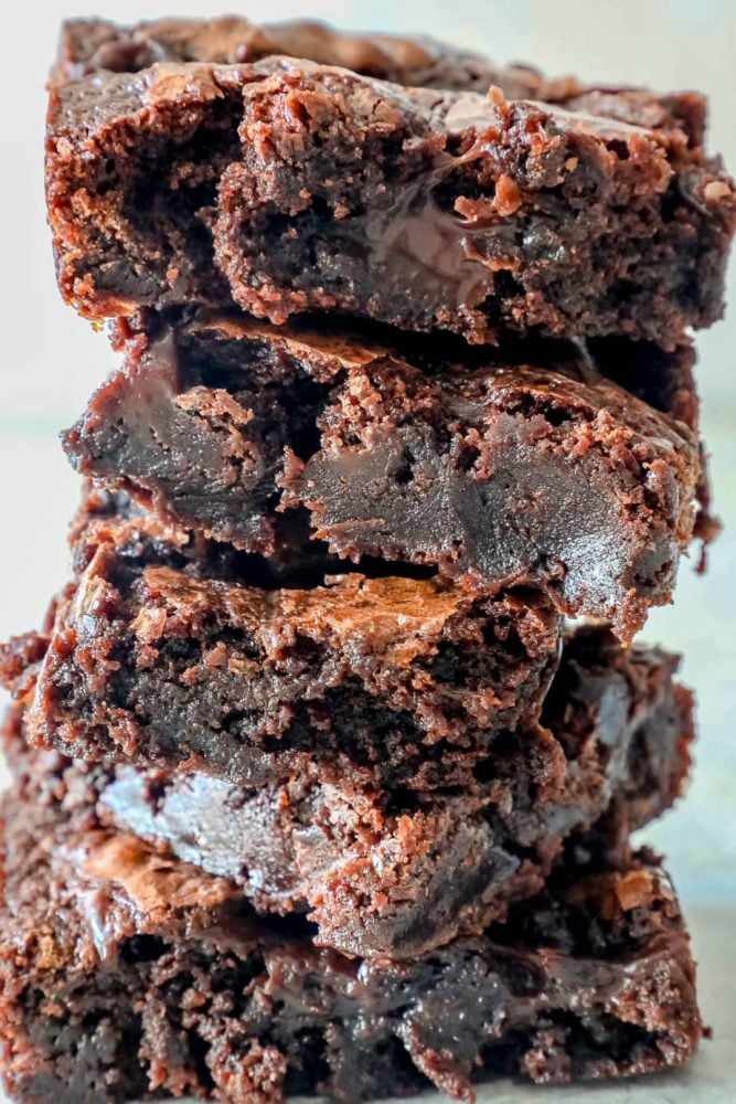 5 brownies stacked with gooey interiors