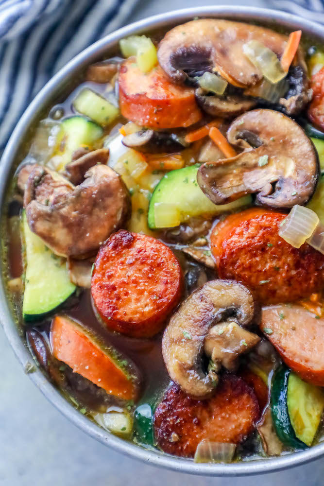 sausage, mushrooms, zucchini in a soup bowl