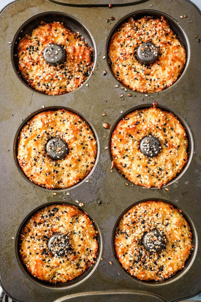 6 keto bagels in a metal donut baking pan. 
