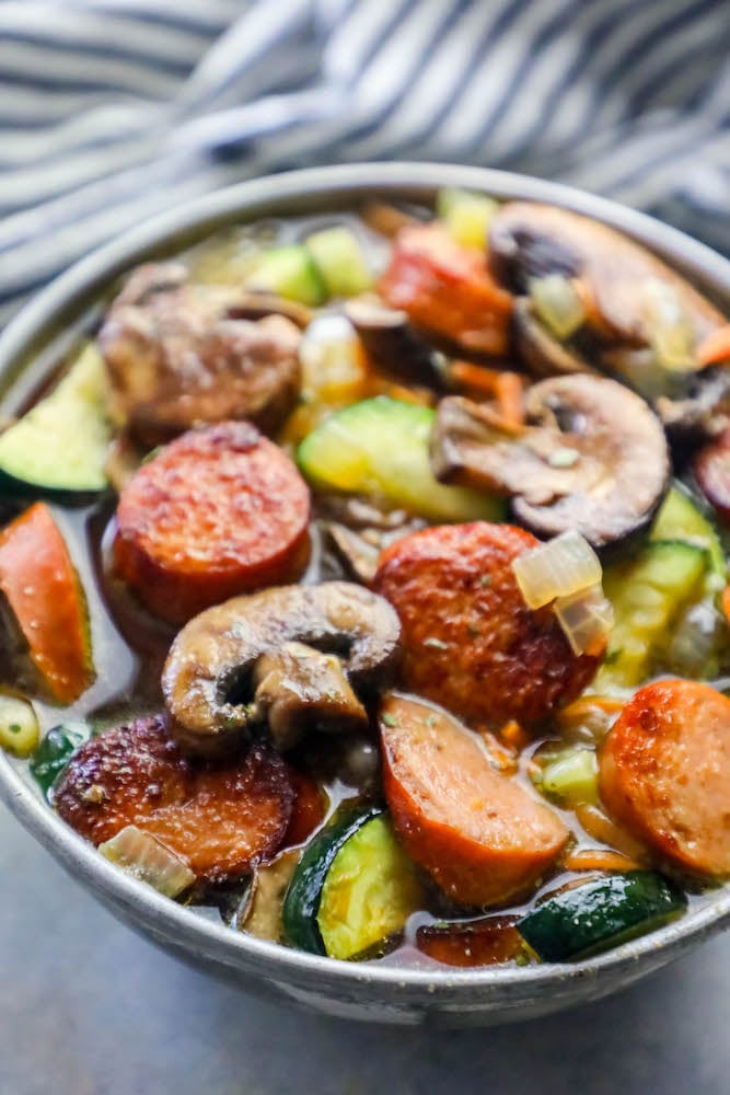 sausage, mushrooms, zucchini in a soup bowl