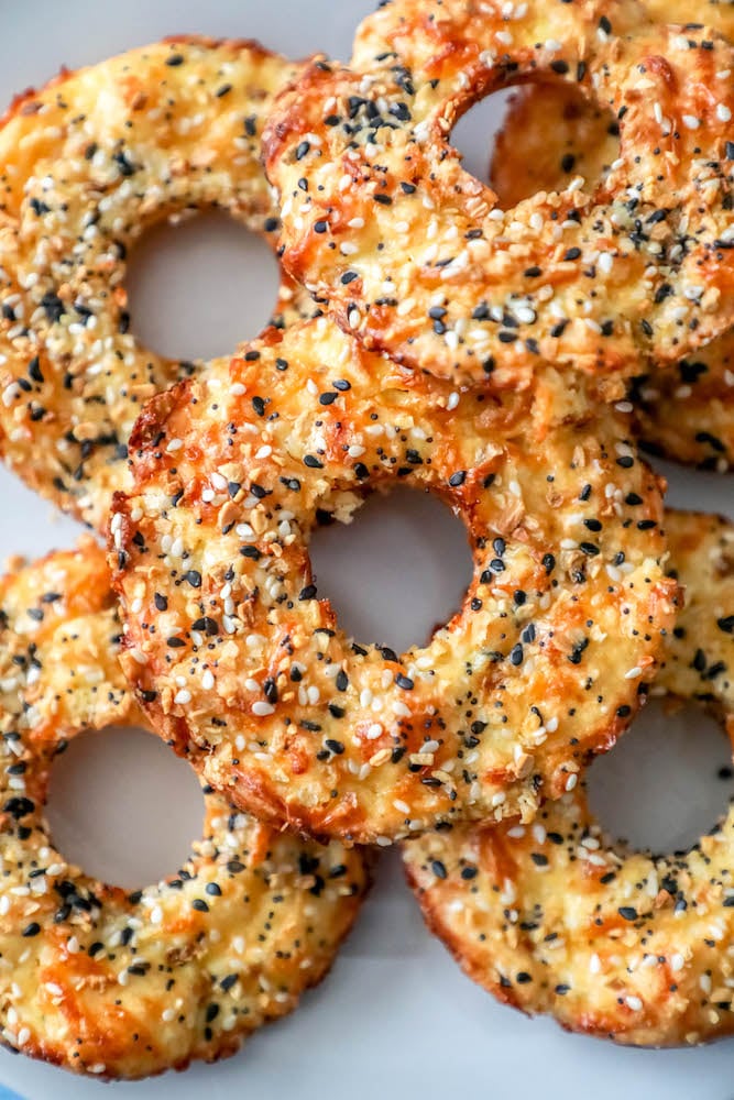 Six keto everything bagels laying on a plate. 