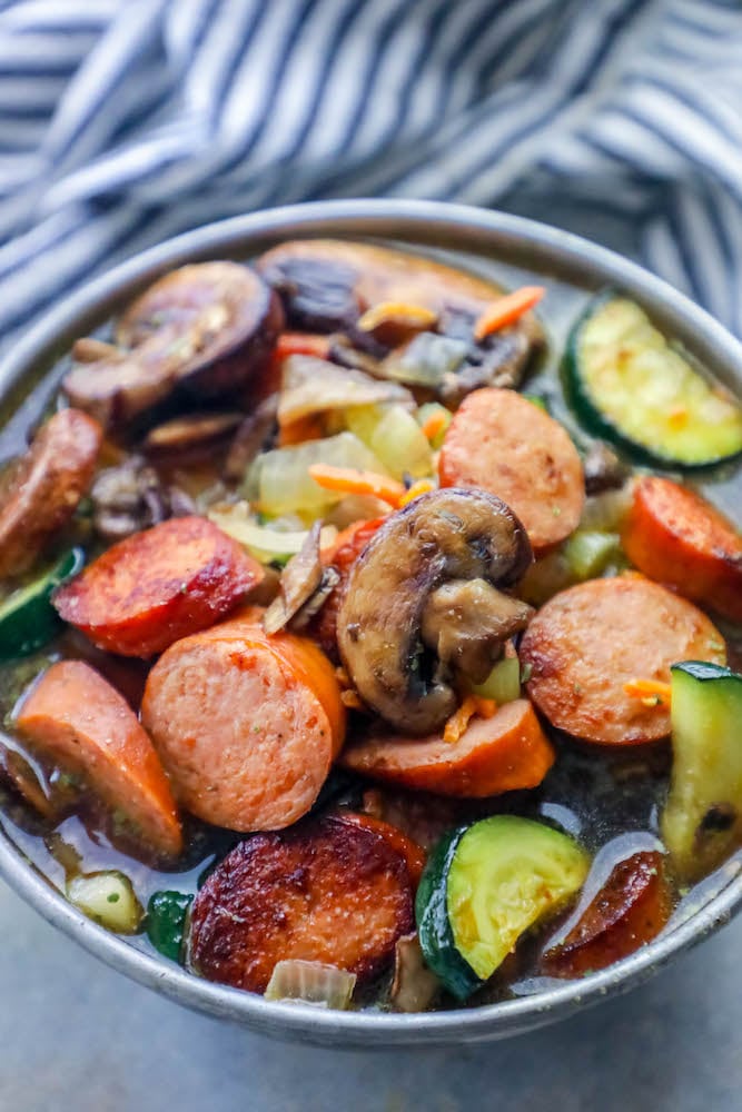 sausage, mushrooms, zucchini in a soup bowl